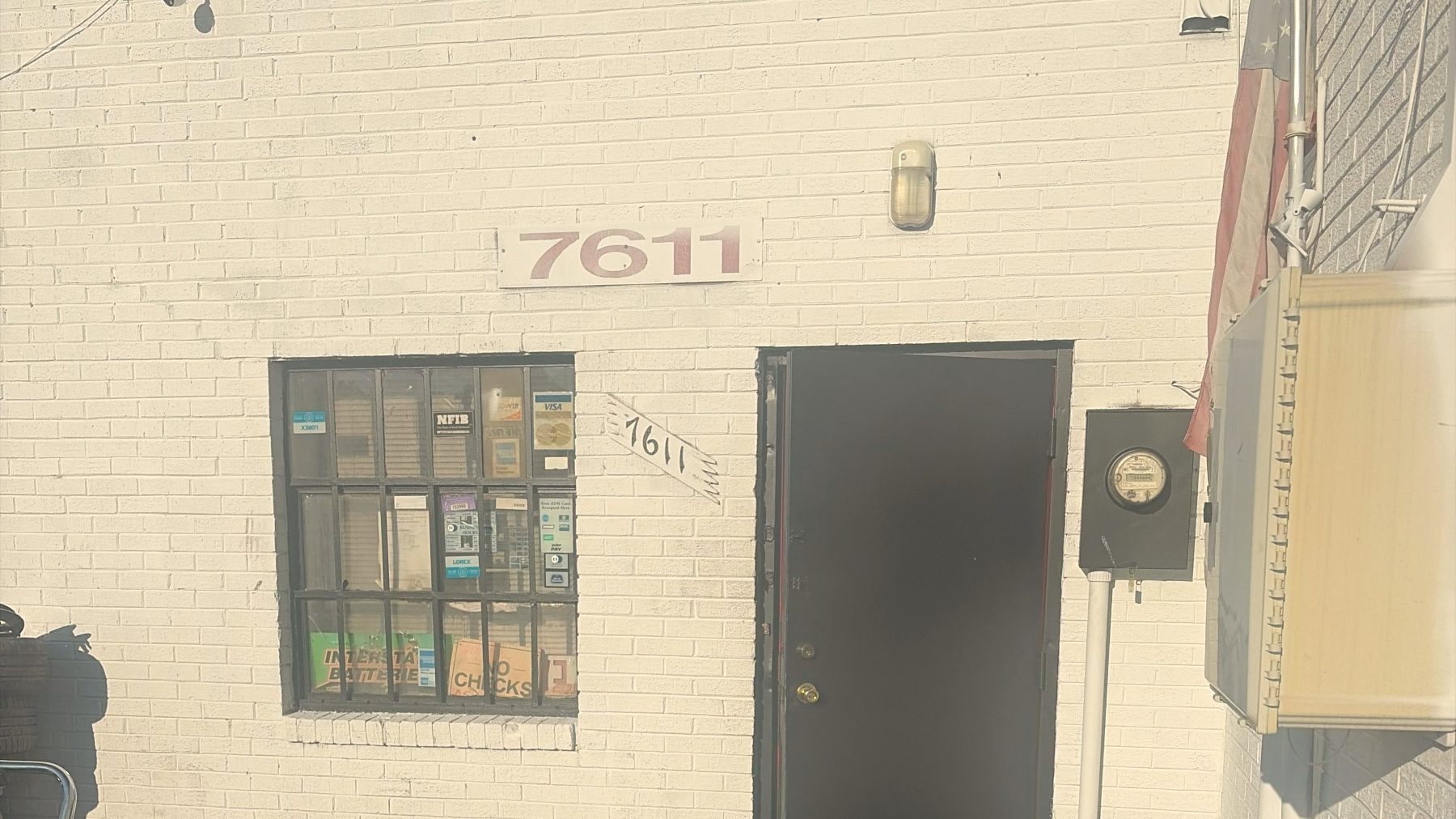 The door with the number 7611 on the wall